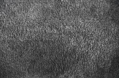 Grey soft fabric rug surface. Gray texture background of the furry carpet.