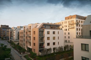 Exterior of a modern apartment buildings with balcony and white walls.