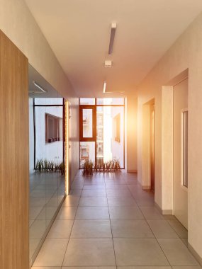 Vertical photo of long house corridor with a wooden door to flats. Indoor concept of a contemporary passage.
