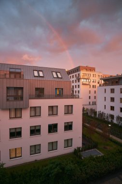 Exterior of a modern apartment buildings with balcony and white walls.