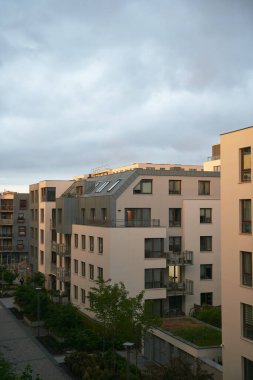 Exterior of a modern apartment buildings with balcony and white walls.
