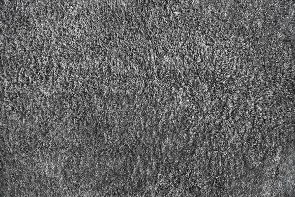 Grey modern floor rug texture. Generic long pile carpet for indoor use.