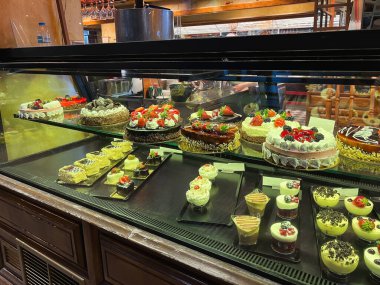 ATHENS, GREECE - MAY 14, 2022: Showcase of a cafe with confectionery on Agiou Konstantinou Street in Athens, Greece