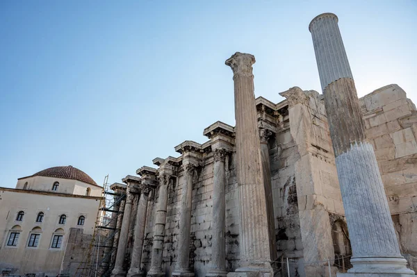 stock image ATHENS, GREECE - MAY 14, 2022: Sunny view of the Library of Hadrian, Athens, Greece. It is one of the main landmarks of Athens. Beautiful scenery of Athens with ancient Greek ruins. Historical architecture of Athens in summer.