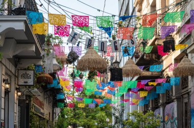 ATHENS, GREECE - MAY 14, 2022: Cafes and shops on Aristophanos street in Athens in Greece