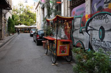 ATHENS, GREECE - MAY 14, 2022: Cafes and shops on Aristophanos street in Athens in Greece