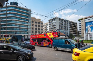 ATHENS, GREECE - MAY 14, 2022: Group of tourists, taking a tour on the open-top double-decker bus Omonia Square