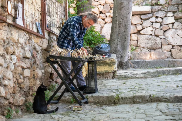 ATHENS, GREECE - MAY 14, 2022: A street vendor of freshly baked corn is waiting for buyers to arrive in Athens.