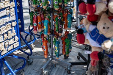 ATHENS, GREECE - MAY 14, 2022: Tourists walk the narrow path between souvenir shops and outdoor vendors selling gifts in the touristic Plaka section of Athens, Greece.