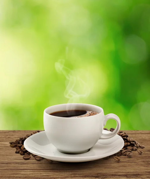 Koffie kop en schotel op een houten tafel (uitknippad). — Stockfoto