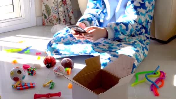 Crop Anonymous Kid Soft Pajama Sitting Floor Surrounded Colorful Toys — Stock Video