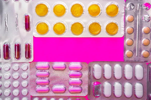 Background of different pill blisters with copy space in the center — Stock Photo, Image