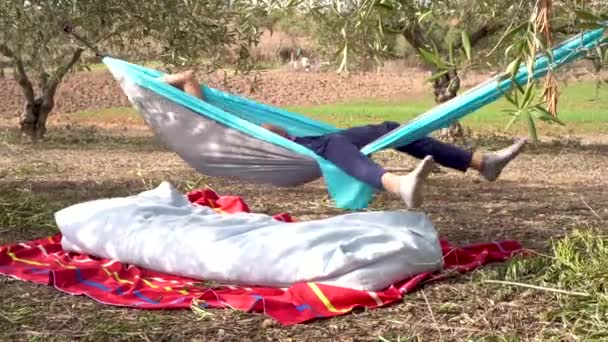 晴れた日に田舎のハンモックで寝ている認識されていない人 自然の中で休息とリラックス — ストック動画
