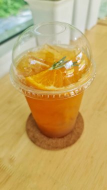 Orange juice mixed with punch Garnished with orange pulp and rosemary leaves.