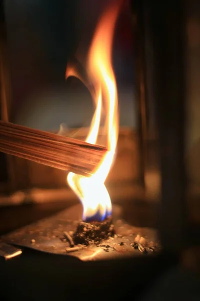 Incense sticks being lit by flames to worship the sacred