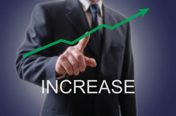 Businessman indicating the increase — Stock Photo, Image