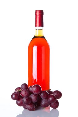 Bottle of rosé wine and red grapes