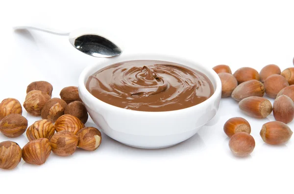 A cup of chocolate hazelnut spread with hazelnuts — Stock Photo, Image