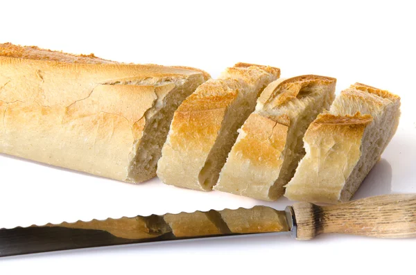 Slices of baguette with a knife — Stock Photo, Image