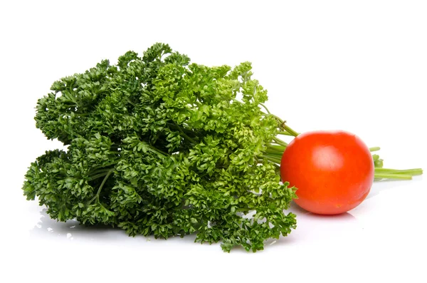 Bunch of parsley with a tomato — Stock Photo, Image