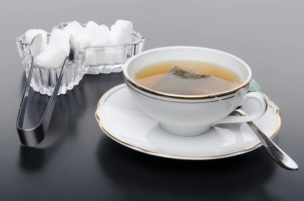 A cup of tea with sugar — Stock Photo, Image