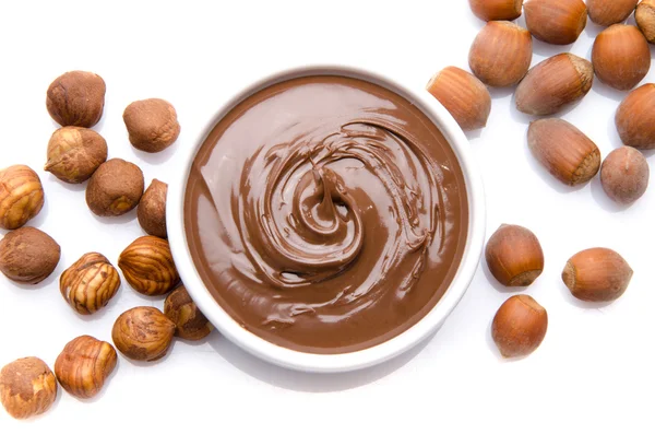 A cup of chocolate hazelnut spread with hazelnuts — Stock Photo, Image
