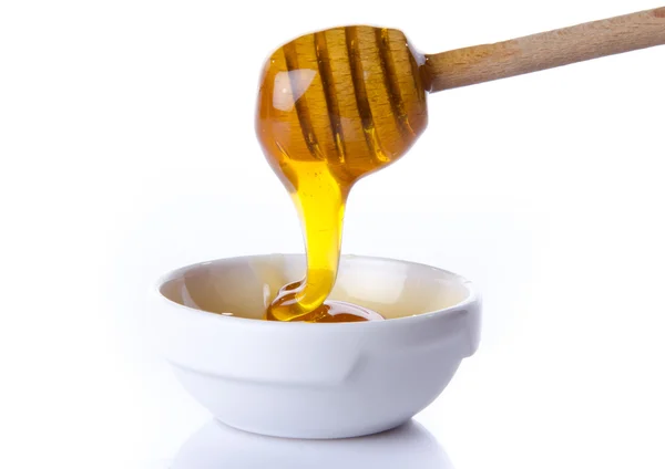 Honey flowing from a  honey dipper — Stock Photo, Image