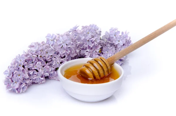 Honey with a lilac flower — Stock Photo, Image