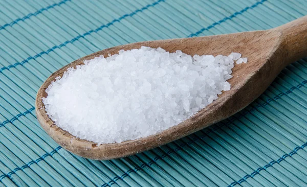 Salt in a wooden spoon — Stock Photo, Image