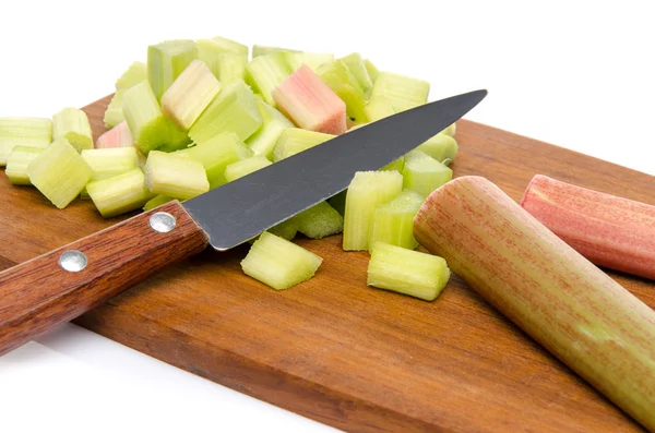 Chopped rhubarb on a wood cutting board — Stock Photo, Image