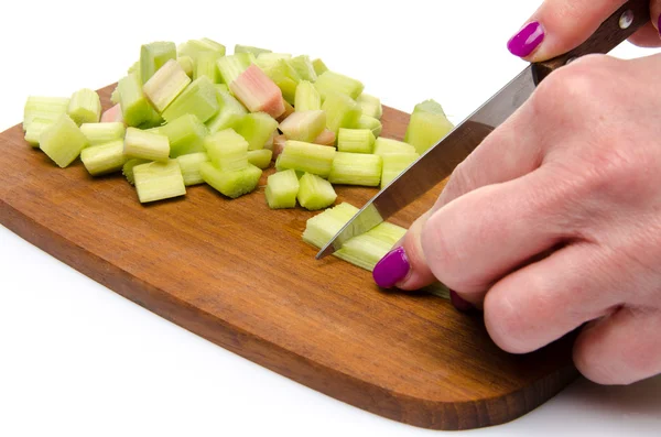 Woman's hand chopping rhubarb — Stock Photo, Image
