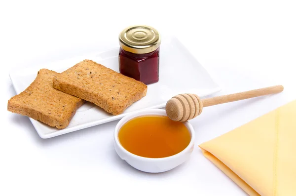 Composition du petit déjeuner, miel, pain grillé, confiture — Photo