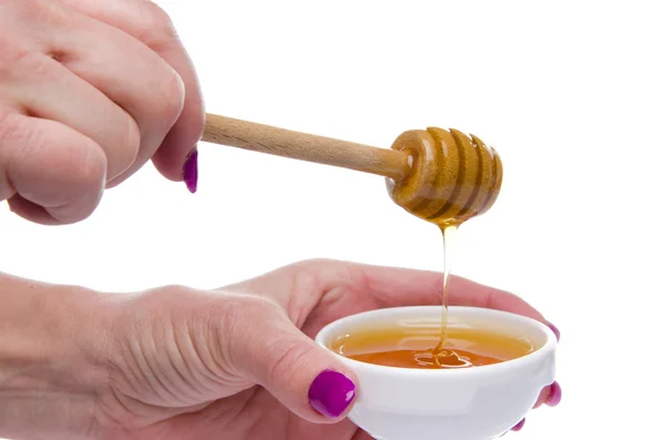 Woman's hand holding a honey dipper — Stock Photo, Image