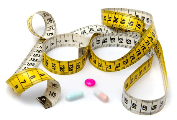 Measuring tape with pills — Stock Photo, Image