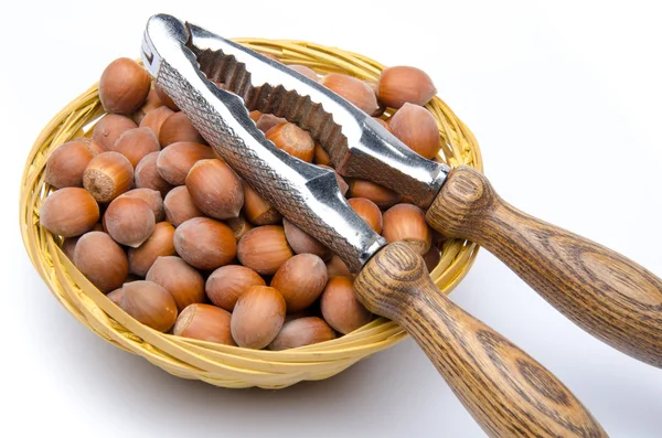 Hazelnuts in a basket with a nutcracker — Stock Photo, Image