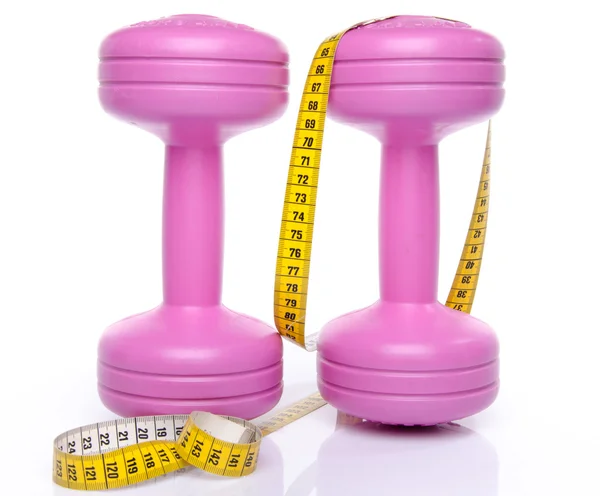 Pink dumbells with a tape measure — Stock Photo, Image