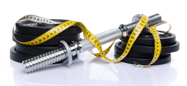 Dumbbell with weights and tape measure — Stock Photo, Image