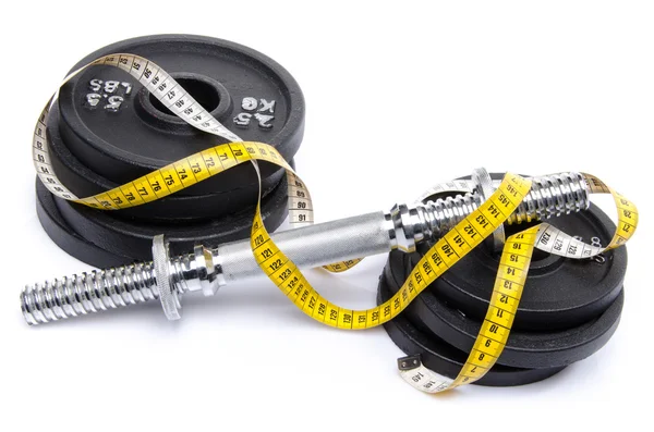 Dumbbell with weights and tape measure — Stock Photo, Image