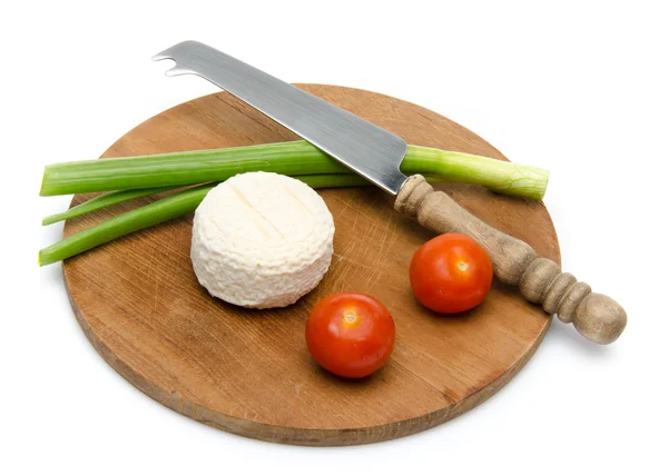 Composition of goat cheese on a wooden cutting board — Stock Photo, Image