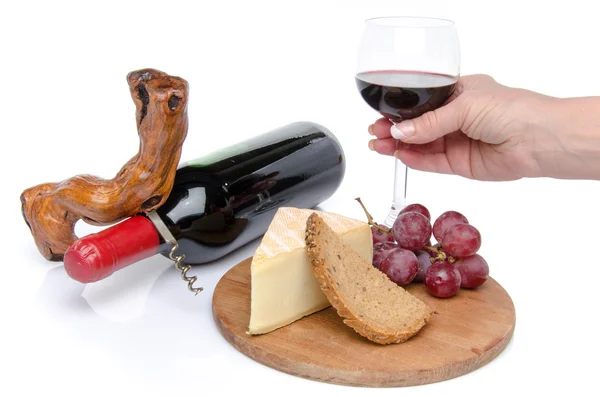 Cheese and red wine with a hand holding a glass — Stock Photo, Image