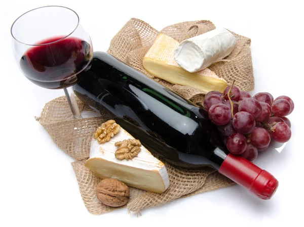 Cheeses, wine and grapes on a burlap — Stock Photo, Image