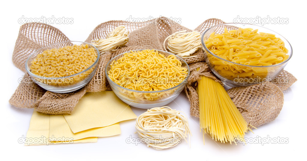 Different types of uncooked pasta on a burlap