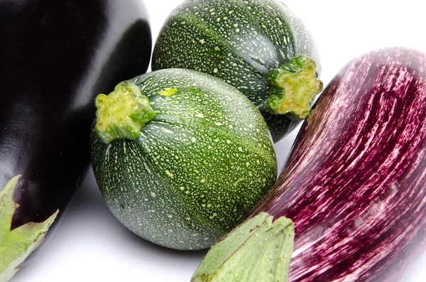 Purple and black eggplant and two zucchini — Stock Photo, Image