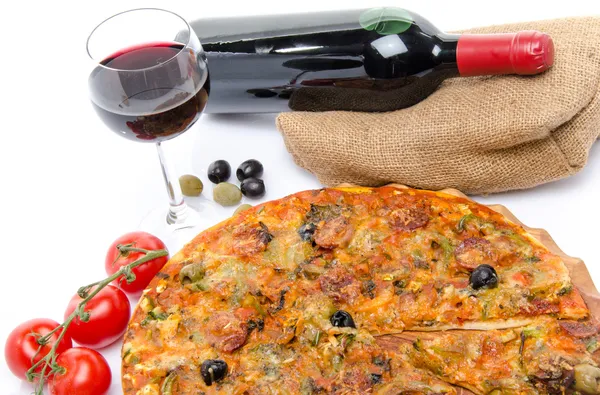 Composition with a pizza, a glass and a bottle of wine — Stock Photo, Image