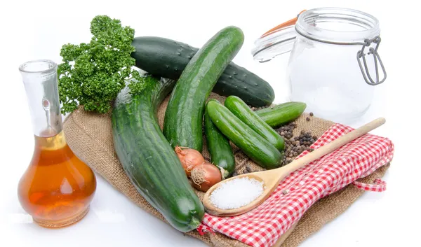 Fresh long and mini cucumbers with some ingredients for putting — Stock Photo, Image