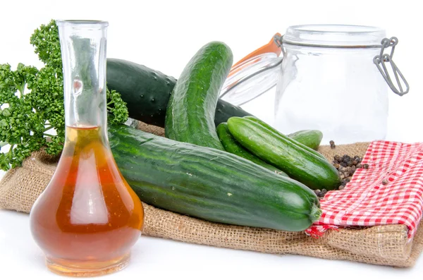Fresh long and mini cucumbers with some ingredients for putting — Stock Photo, Image