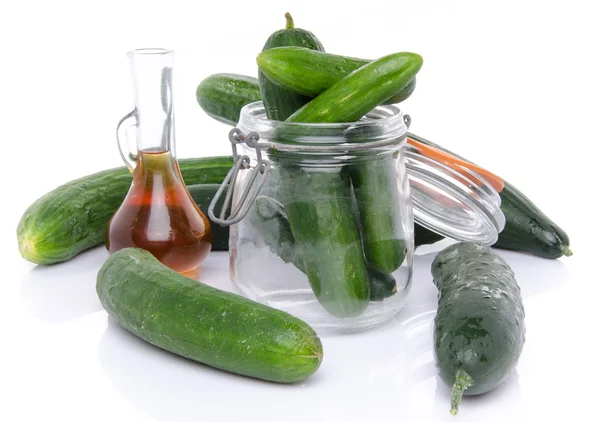 Composition with cucumbers, a glass jar and vinegar — Stock Photo, Image