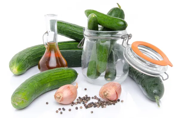 Composition with cucumbers, a glass jar and vinegar — Stock Photo, Image