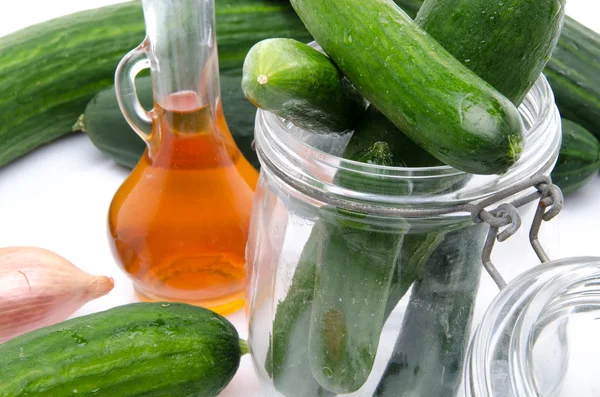 Composition with cucumbers, a glass jar and vinegar — Stock Photo, Image