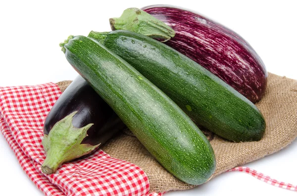 Eggplants and zucchini on a burlap bag — Stock Photo, Image